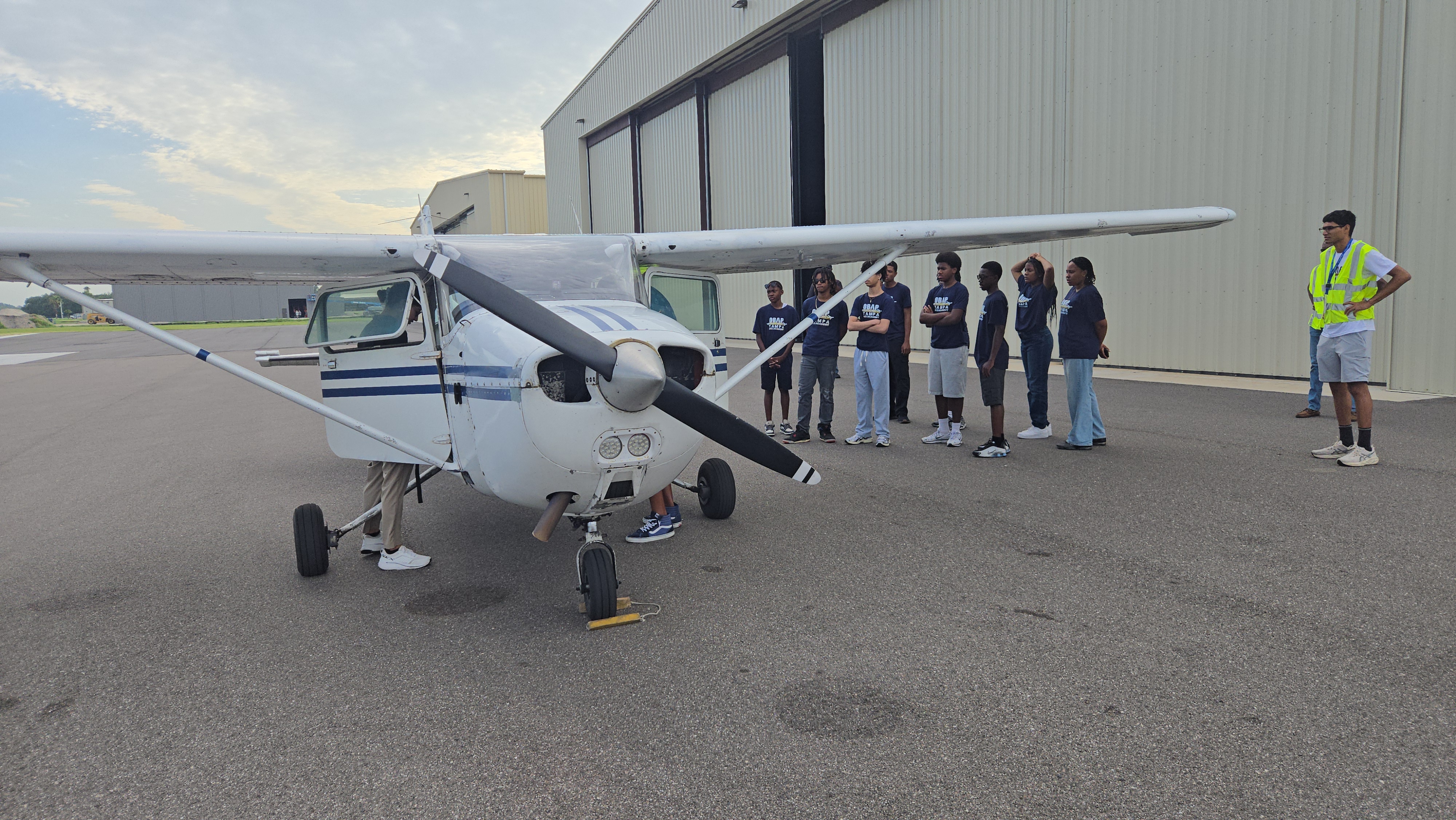 Pilot student standing with an airplane